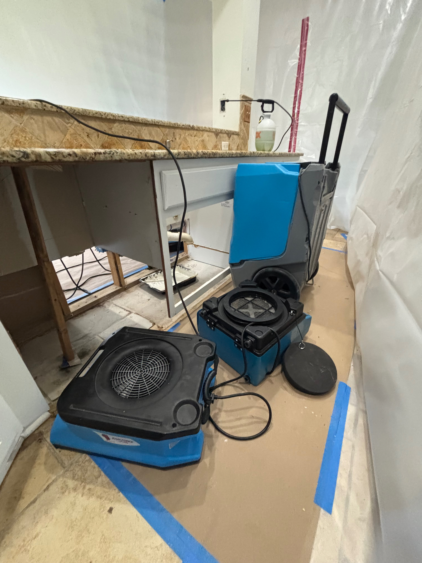 Emergency water damage restoration job site in Cedar Park, TX — air movers, LGR dehumidifier and HEPA air scrubber for water mitigation and structural drying